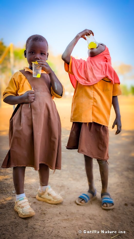 Two students sharing a drink outdoors